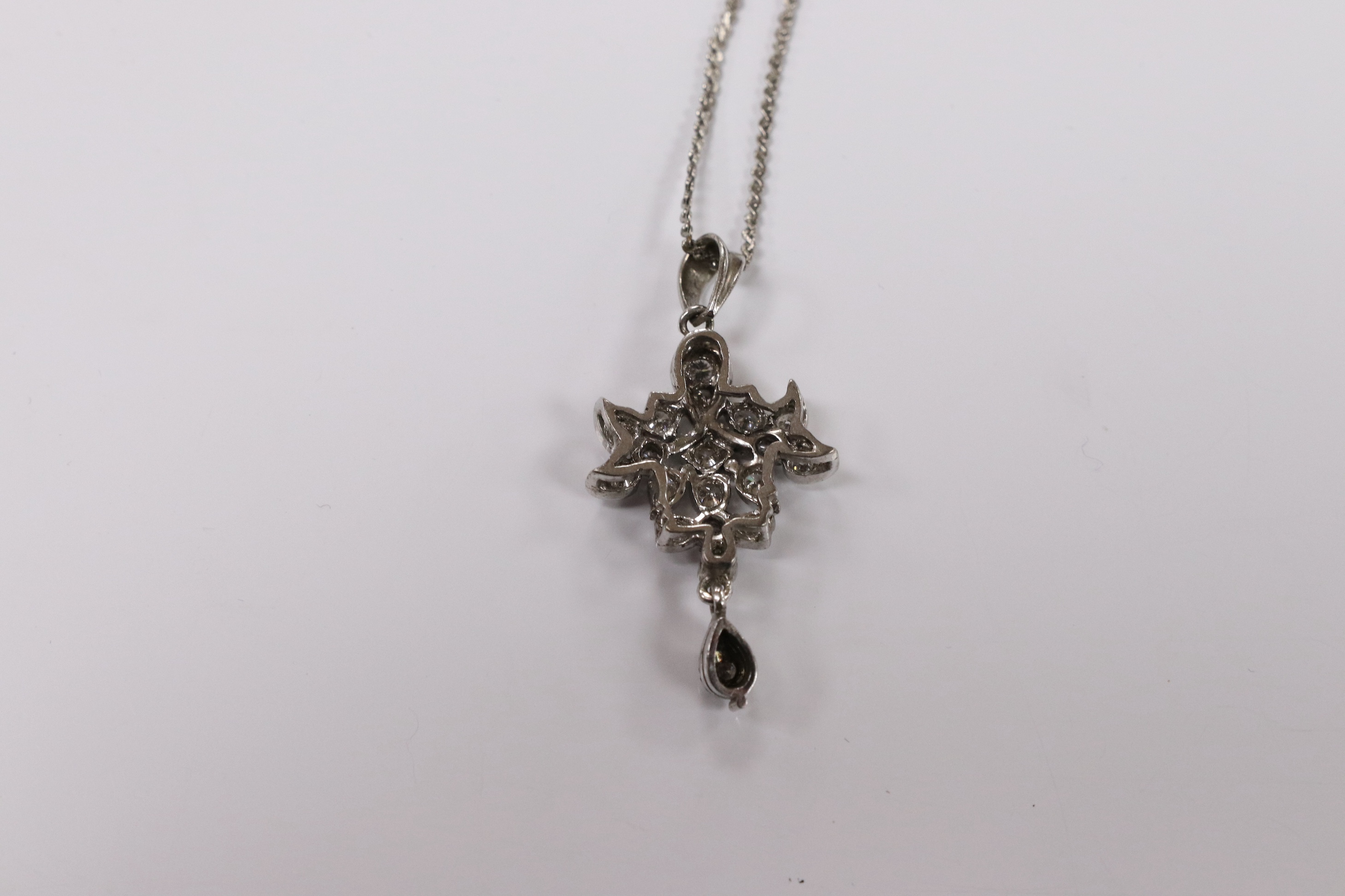 A modern white metal and diamond chip cluster set drop pendant, 33mm, on a base metal chain. Condition - fair